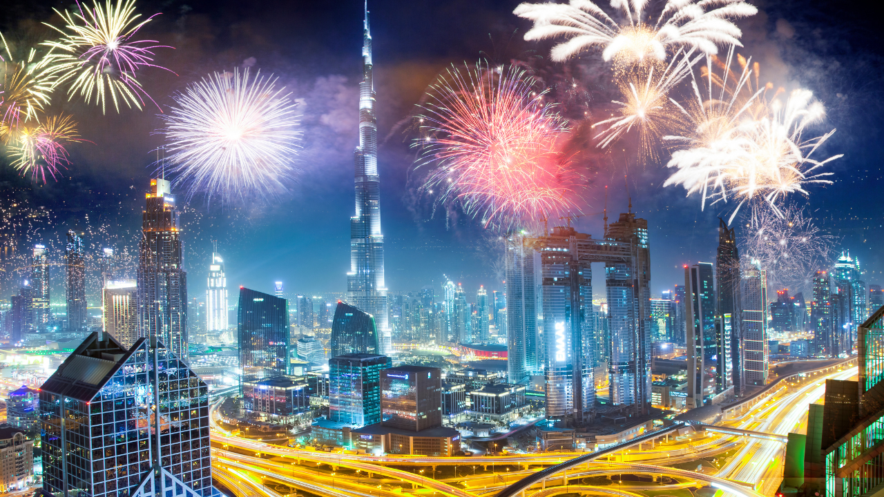 Fireworks lighting up the Dubai skyline on UAE National Day with iconic landmarks in the background